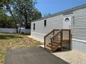 Charming single-story home featuring a freshly painted exterior and a newly built wood staircase at 11351 Edison Ave, New Port Richey, FL 34654