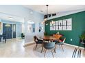 Contemporary dining room features stylish decor, modern light fixture and art at 12456 Spreading Oak Dr, Spring Hill, FL 34609