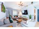 Cozy living room with comfortable seating, large TV, and modern decor at 12456 Spreading Oak Dr, Spring Hill, FL 34609