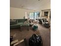 Image shows a cluttered living room with boxes and an open view of the kitchen at 135 Pinewinds Blvd, Oldsmar, FL 34677