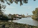 Picturesque waterfront property with boat dock, surrounded by lush greenery and clear, calm waters at 1980 Forked Creek Dr, Englewood, FL 34223