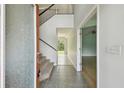 Bright foyer featuring tile flooring, staircase, and an open layout at 27012 Sea Breeze Way, Wesley Chapel, FL 33544