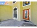 Up-close view of front entrance with arched windows, and a covered entry at 27012 Sea Breeze Way, Wesley Chapel, FL 33544