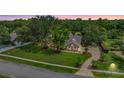 Sprawling estate featuring lush green lawns, mature landscaping, and a circular driveway at 2769 St Andrews Blvd, Tarpon Springs, FL 34688