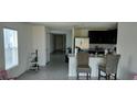 Open-concept space features a kitchen with a breakfast bar and seating at 2880 Gumbo Limbo Dr, Wimauma, FL 33598