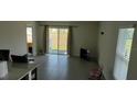 Bright living room with sliding glass doors to the backyard at 2880 Gumbo Limbo Dr, Wimauma, FL 33598