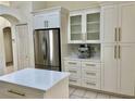Modern kitchen with stainless steel appliances, island with quartz countertop, and white cabinets at 29228 Yarrow Dr, Wesley Chapel, FL 33543