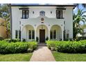 Charming two-story home featuring an arched entryway, red tile roof and neatly landscaped front yard at 3212 W Fountain Blvd, Tampa, FL 33609