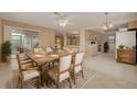 Inviting dining area with a large wooden table, comfortable seating, and seamless access to the kitchen at 3569 Oak Lake Dr, Palm Harbor, FL 34684