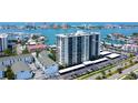 Stunning aerial view of a waterfront condo building with boat docks, parking, and beautiful water views at 400 Island Way # 1709, Clearwater Beach, FL 33767