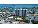 Aerial view showcasing the condo building, parking area, and inviting community pool at 400 Island Way # 1709, Clearwater Beach, FL 33767