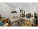 Bright living room featuring a comfortable sofa, stylish rug, and decorative shelf, perfect for relaxing at 4108 N Thatcher, Tampa, FL 33614