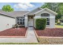 Inviting home entrance with decorative rock garden and walkway at 4708 Ranch Grove Ct, Valrico, FL 33596
