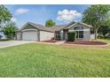 Charming single-story home with a well-manicured lawn and a three-car garage at 4708 Ranch Grove Ct, Valrico, FL 33596