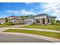 Charming single-story home with well-manicured lawn, stone accents, tile roof, and paver driveway at 4831 Rosatti Rd, Wesley Chapel, FL 33543