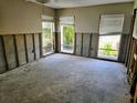 Bedroom with many windows awaiting renovation, offering a blank canvas to create a unique space at 5012 Ensign Loop, New Port Richey, FL 34652