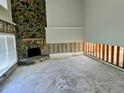 Spacious living room with stone fireplace and large windows that flood the space with natural light at 5012 Ensign Loop, New Port Richey, FL 34652