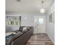 Cozy living room features modern decor, gray sofa, and a lovely front door view at 5193 Boyle Ter, Port Charlotte, FL 33981