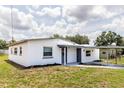 Well-maintained home with fresh white paint and gray trim, highlighted by a neatly kept lawn at 5210 S 80Th St, Tampa, FL 33619