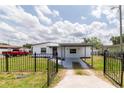 Lovely home with black fence and inviting gray walkway leading to the entrance at 5210 S 80Th St, Tampa, FL 33619
