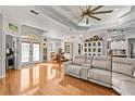 Open-concept living room with a comfortable sofa, hardwood floors, and a view of the dining area at 5296 Slater Rd, Spring Hill, FL 34608