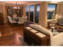 A living room and dining area are visible with views of the city lights from the balcony at 5701 Mariner St # 701, Tampa, FL 33609