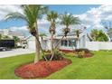 Charming single-story home with a well-maintained front yard, mature palms, and a two-car garage at 6010 Bayou Grande Ne Blvd, St Petersburg, FL 33703