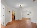 Bright living room with hardwood floors, open archway, recessed lighting, and an adjacent kitchen view at 6109 16Th St, Zephyrhills, FL 33542