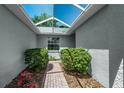 The property features a cozy entrance with a skylight roof and lush green plants at 7253 Cleopatra Dr, Land O Lakes, FL 34637