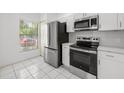 Updated kitchen featuring stainless steel appliances, white cabinets, and ample natural light at 8612 Hunters Key Cir, Tampa, FL 33647
