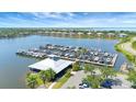 Picturesque aerial view of marina with numerous boats docked on calm water, surrounded by homes at 915 Tidewater Shores Loop, Bradenton, FL 34208