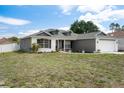 Attractive single-story home featuring dormer windows and a well-maintained front lawn at 10101 Langan St, Spring Hill, FL 34608