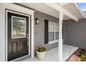 Close-up of the front door showcasing the entrance and house number with a porch and window at 10101 Langan St, Spring Hill, FL 34608