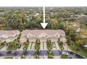 Aerial view of a residential street highlighting townhouse row with well maintained landscaping at 11162 Kapok Grand Cir, Madeira Beach, FL 33708