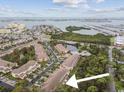 Aerial view of townhouse complex near water, showcasing location and community layout at 11162 Kapok Grand Cir, Madeira Beach, FL 33708