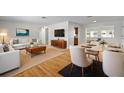 Bright living room with hardwood floors and a view of the dining area and kitchen at 11762 82Nd Ter, Seminole, FL 33772