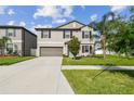 Charming two-story home features well-manicured landscaping, a spacious driveway, and a two-car garage at 13529 Wild Ginger St, Riverview, FL 33579