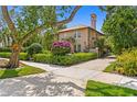 Charming two-story home with a well-manicured front yard and vibrant landscaping at 136 W Davis Blvd, Tampa, FL 33606