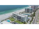 Aerial view of beachfront condo showing the community pool, landscaping, and beach access at 1400 Gulf Blvd # 306, Clearwater Beach, FL 33767