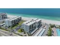 Aerial view of beachfront condos highlighting location, parking and beach access at 1400 Gulf Blvd # 306, Clearwater Beach, FL 33767