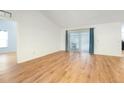 Hardwood floored living room featuring sliding glass doors at 1624 Shady Leaf Dr, Valrico, FL 33596