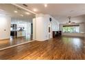 Spacious living room with wood floors, mirrored wall and plenty of natural light at 2008 Berry Lake Dr, Brandon, FL 33510