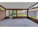 Spacious enclosed porch with wood trim and views of the fenced backyard at 2048 Los Lomas Dr, Clearwater, FL 33763