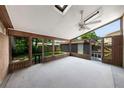 Enclosed porch features wood trim, large windows, and a ceiling fan at 2048 Los Lomas Dr, Clearwater, FL 33763