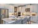 Modern kitchen featuring stainless steel appliances, a large island, and elegant white cabinetry at 33284 Castaway Loop, Wesley Chapel, FL 33543