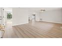 Bright, airy living room with new floors, leading to kitchen and backyard with lake views at 3431 Springfield Dr, Holiday, FL 34691
