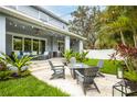 Inviting backyard with a patio, outdoor seating, landscaping and string lights at 3611 W Royal Palm Cir, Tampa, FL 33629
