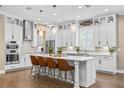 Modern kitchen with stainless appliances, marble counters, island and pendant lighting at 3611 W Royal Palm Cir, Tampa, FL 33629