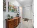 Inviting entryway with tiled floor, decorative furniture, and stylish accents at 3876 Crossline Dr, Spring Hill, FL 34609