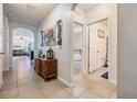 Hallway leading to living area, bedroom, and bathroom with tile floor at 3876 Crossline Dr, Spring Hill, FL 34609
